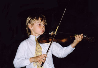 Pupil mid-performance, demonstrating good bow hold and left hand positions